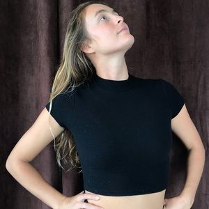 Black crop top with long skirt.